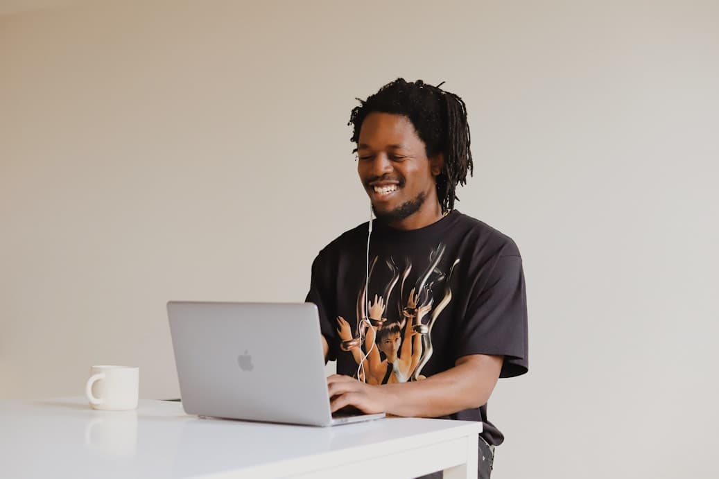 Smiling tech professional working on a laptop